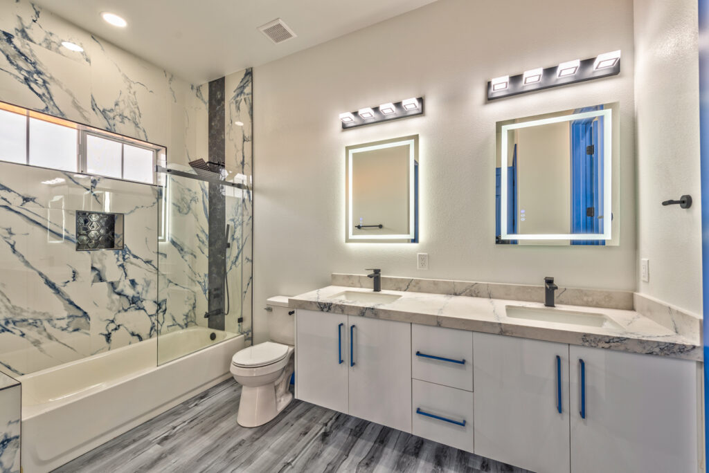Summerlin Las Vegas Modern bathroom remodel with marble tile shower, dual vanity, and LED backlit mirrors