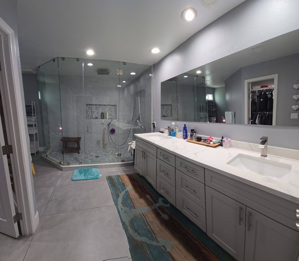 Bathroom remodel in Paradise Las Vegas featuring glass walk-in shower, dual vanity, and custom tilework