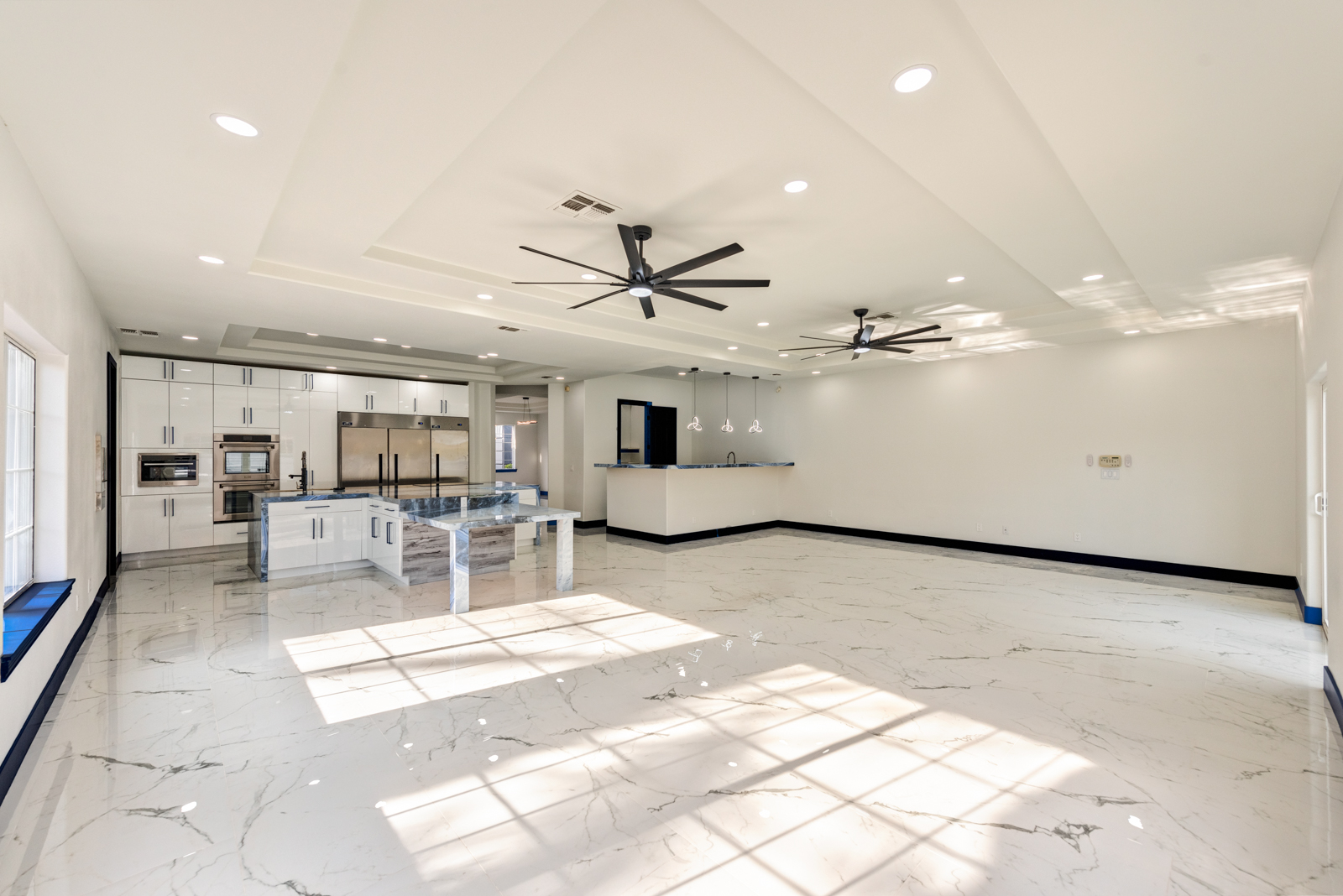 Open-concept kitchen remodeling project in Las Vegas featuring luxury kitchen with island and marble flooring