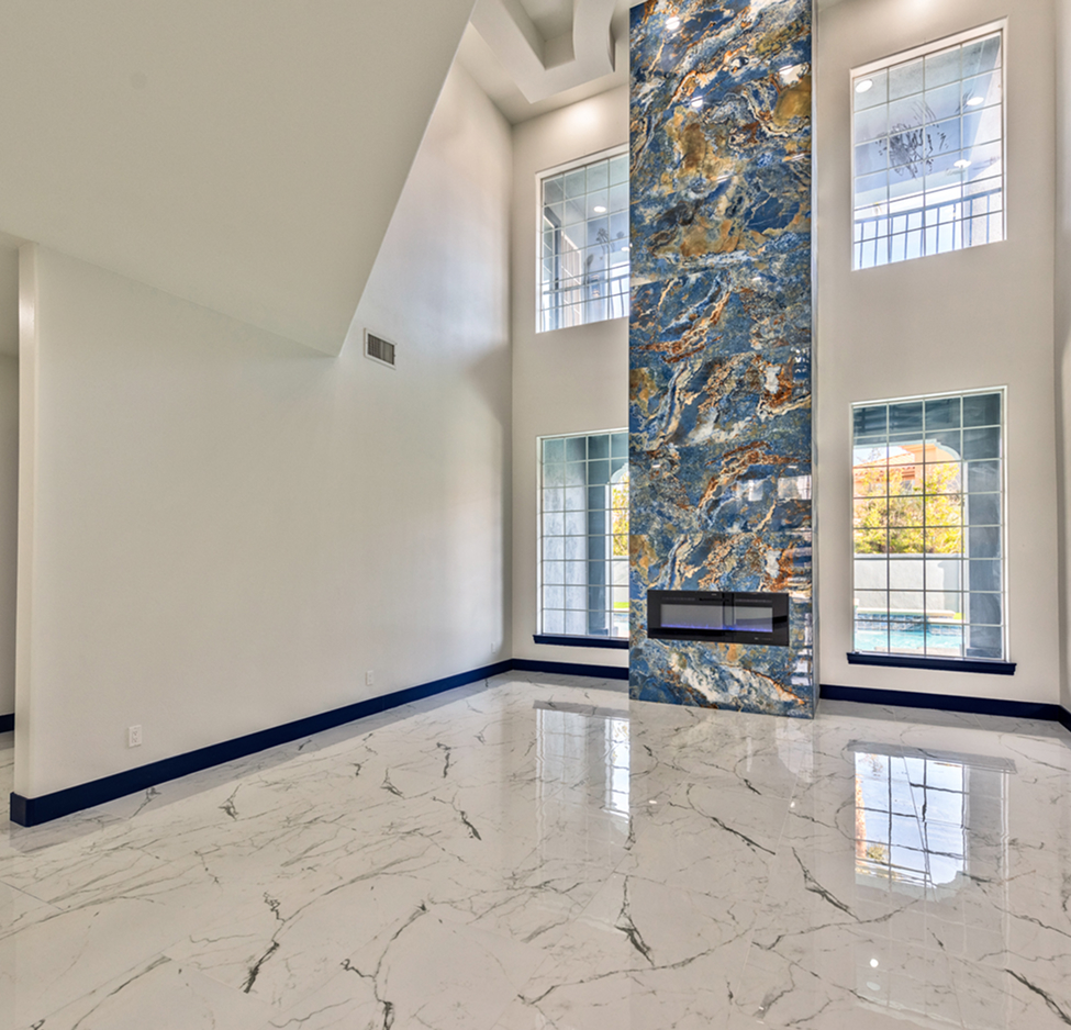 Modern home remodeling project in Las Vegas featuring marble flooring and a custom blue accent fireplace wall