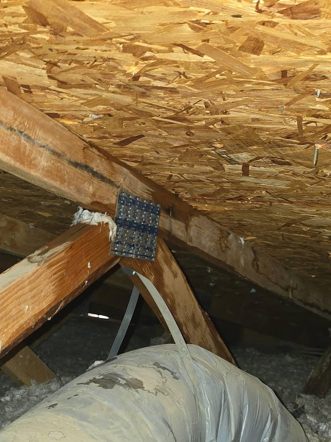 Water stains on attic wood framing and HVAC duct in a residential Las Vegas home
