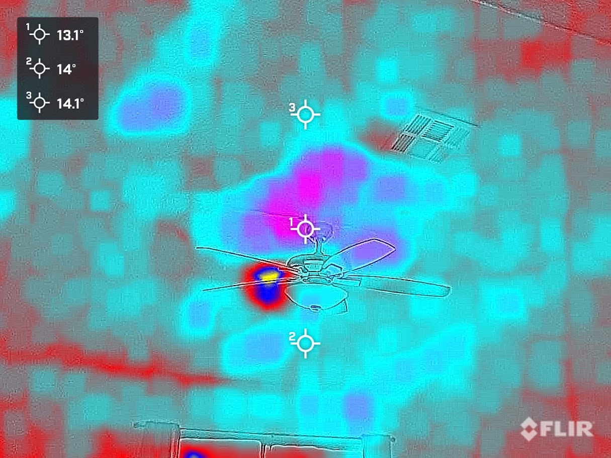 Thermal image showing cold spots and potential moisture intrusion in the ceiling near a ceiling fan
