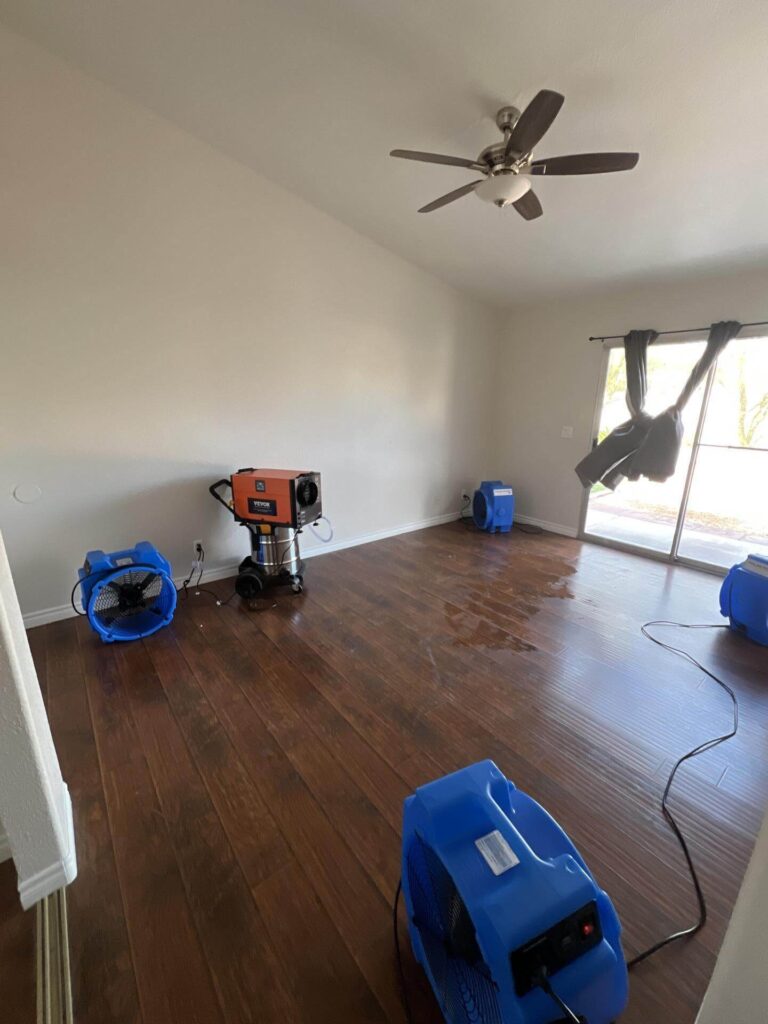 Drying equipment set up on hardwood floor after water damage