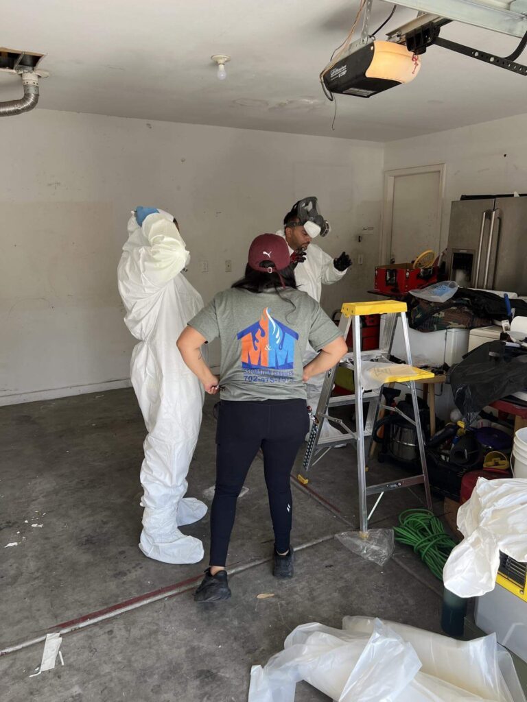Restoration team preparing for repair work in a garage after water damage