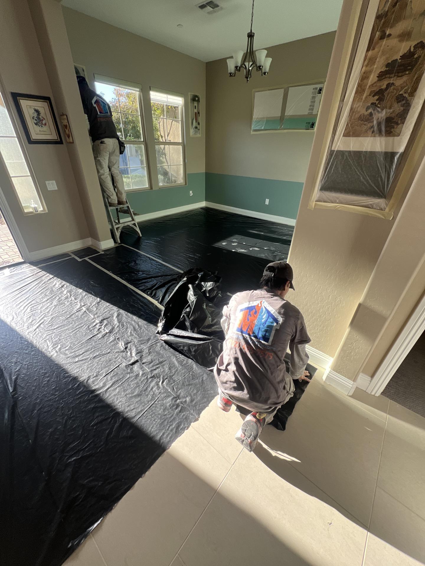 M&M Restoration crew laying floor protection during water damage restoration in a Las Vegas home